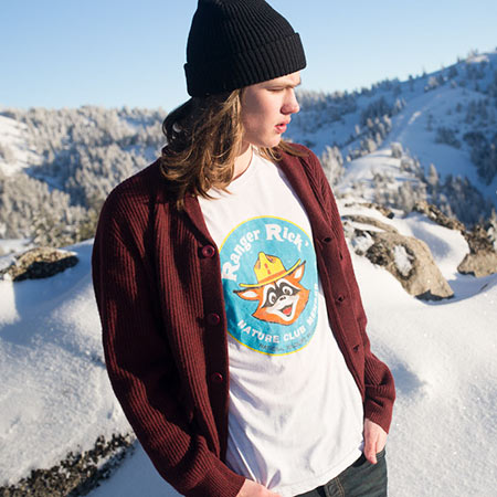 Young man wearing a Ranger Rick Shirt on a snowy mountain