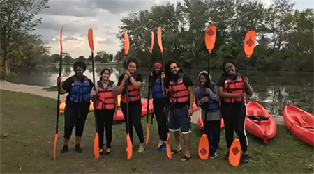 NWF staff stand in front of kayaks